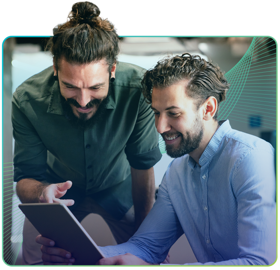 two men smiling looking at tablet